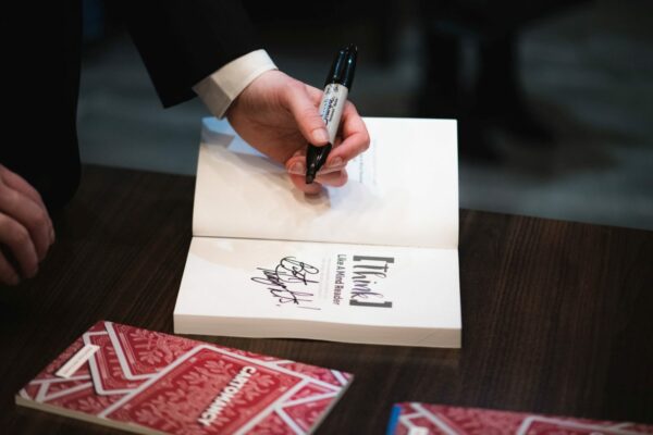 Author Jonathan Pritchard autographing his book Think Like A Mind Reader.